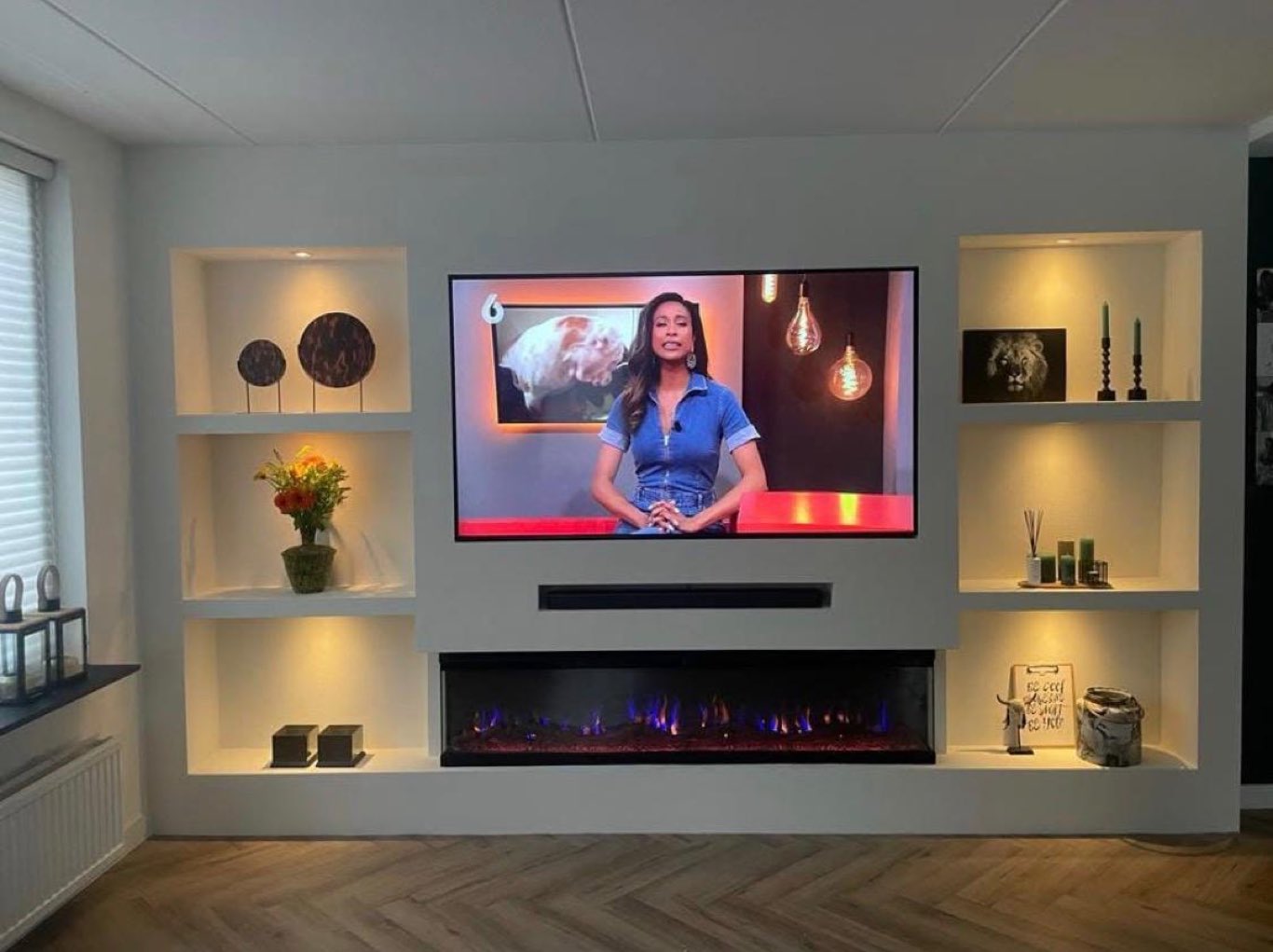 Ruime mediawand met verlichte wandkasten